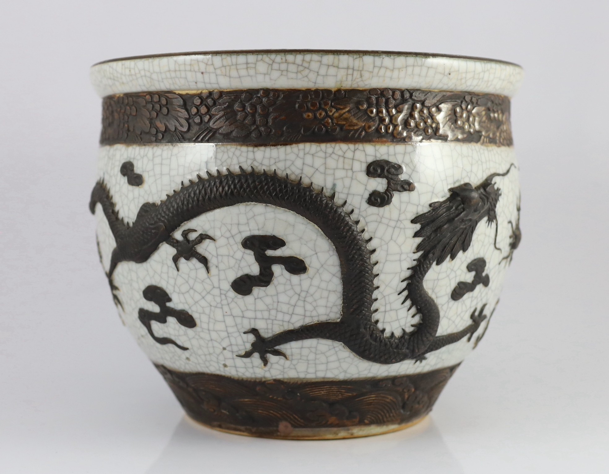 A Chinese crackle glaze 'dragon' jardiniere, late 19th century, 31.6cm diameter, 25.5cm high, star crack to base